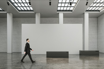 Poster - Businessman walking in contemporary exhibition hall interior