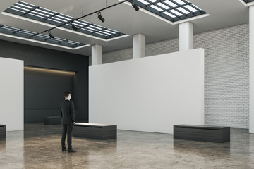 Poster - Businessman sstanding in exhibition hall interior