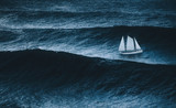 sailboat on the sea with storm and big waves