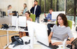 © JackF - adult serious business people working and communicating together in modern open plan office