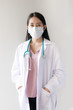 © amornchaijj - Portrait of young Asian female doctor wearing a mask with stethoscope on white background. healthcar and medical concept.