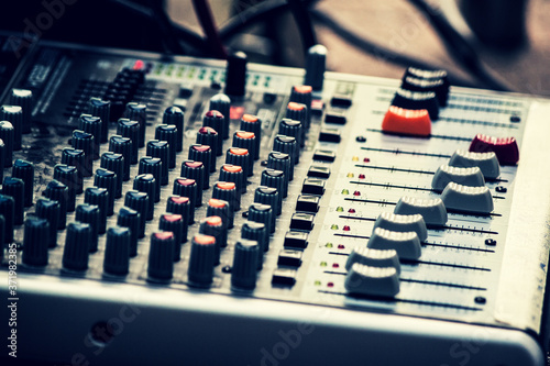Fotomural audio mixing console with knobs and faders
