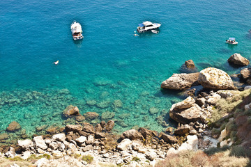 View of the Tremiti Islands. Boats near a rock stone coast.