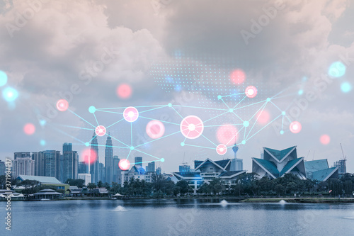 Fotografía Abstract technology icons hologram over panorama city view of Kuala Lumpur, Malaysia, Asia