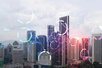 abstract technology icons hologram over panorama city view of kuala lumpur, malaysia, asia. the conc