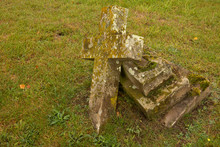 Aged Broken Cross Grave Stone In Old English Graveyard