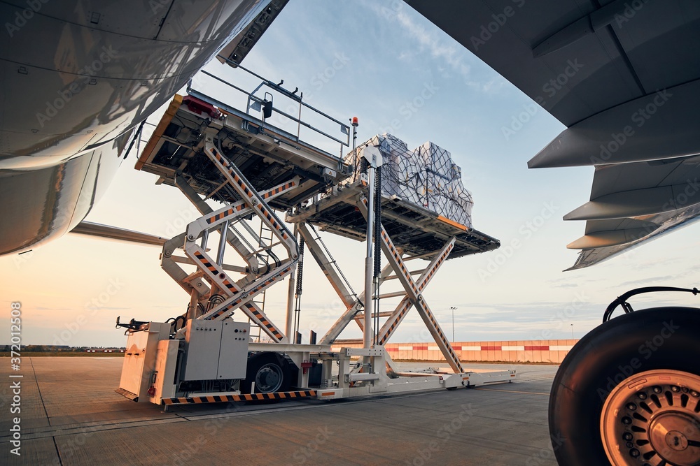 Loading of cargo containers to airplane - obrazy, fototapety, plakaty 