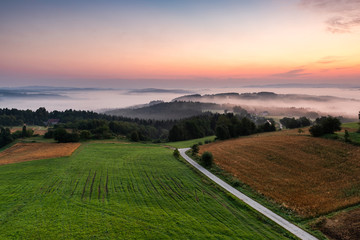 Wall Mural - Rolling Hills in Morning Fog at Sunrise in Coutryside in Poland