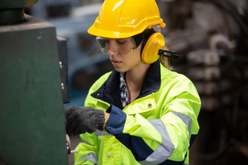 engineer at work, Portrait of female Engineer standing with confident against machine environment in factory, Engineers operating a machine in factory