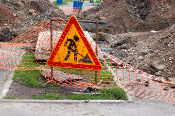 Road works sign, hazardous area fencing. Communal accident, pits and embankments, photo