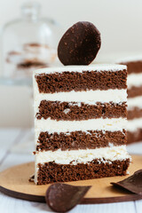 Wall Mural - a piece of chocolate cake with white cream and a piece of chocol