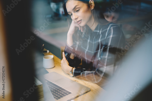 Fotografía Young attractive student feeling tired watching training webinar on laptop compu