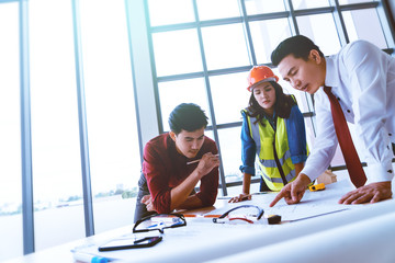 Wall Mural - Construction team with business man engineer and architect is brainstorming on working table with copy space on side