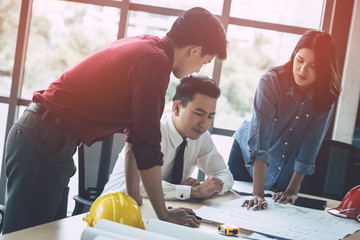 Wall Mural - Construction Boss with business man engineer and architect is discussing on working table with building plan