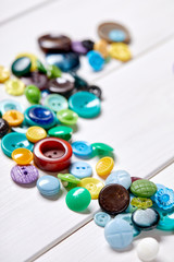 Fototapete - Background and texture of multicolored antique buttons