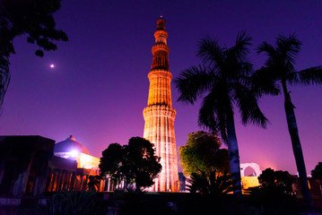 Wall Mural - Silhouette of Qutub Minar a highest minaret in India standing 73 m tall tapering tower of five storeys made of red sandstone. It is UNESCO world heritage site at  New Delhi,India