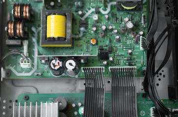 Poster - A close-up microchip with many electrical components placed on the Board. The background is blurred.
