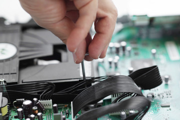 Poster - Hands with tools for repair computer. Blurred background.