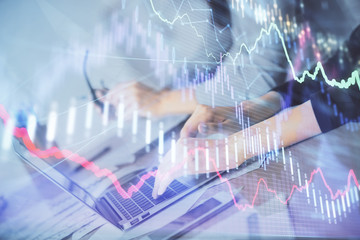 Multi exposure of woman hands typing on computer and financial chart hologram drawing. Stock market analysis concept.