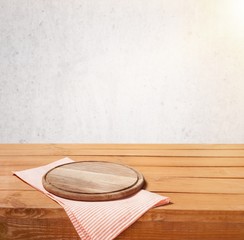 Wall Mural - Wooden cutting board and tablecloth on wooden table