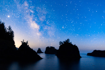 Wall Mural - starry night sky and milky way over sea stack island on the oregon coast