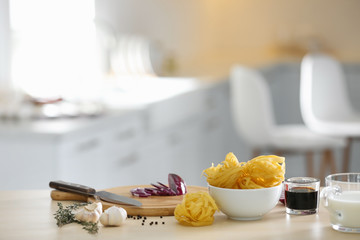 Fresh products and cutting board on kitchen table. Cooking healthy food