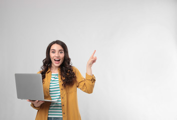 Poster - Young woman with laptop on white background