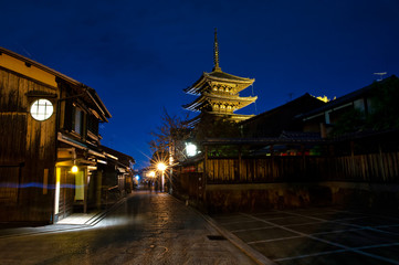 Wall Mural - cityscape in a small street in kyoto you can see yasaka shrine, at dusk where the streets are shaded