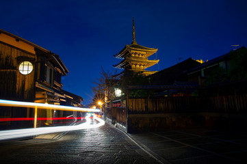 Wall Mural - cityscape in a small street in kyoto you can see yasaka shrine, at dusk where the streets are shaded