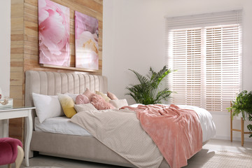 Poster - Stylish room interior with large comfortable bed and beautiful paintings