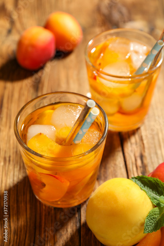 Delicious refreshing drink with apricot on wooden table