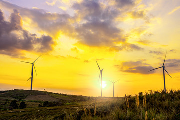 Wall Mural - night scene of landscape mountain view with windmills on the hill with sunset sky, wind turbine gene