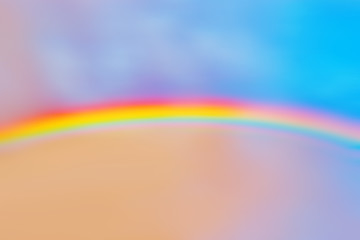 Wall Mural - pastel rainbow landscape across sunset cloudy sky background. Natural color of sky with rainbow. Weather environment after rain. Design wallpaper