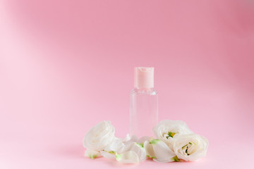 Wall Mural - Hand cream with flowers. Delicate skin care concept. Top horizontal view copyspace