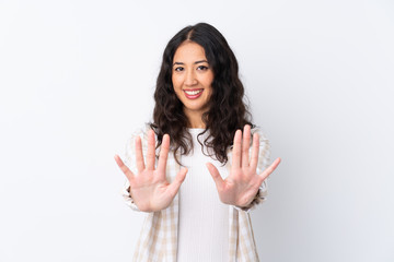 Wall Mural - Mixed race woman over isolated white background counting ten with fingers