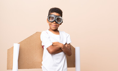 Poster - African American boy  with aviator hat and with wings over isolated background