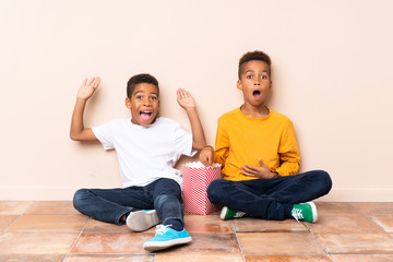 Wall Mural - African American brothers  holding popcorns and doing surprise gesture