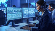 © Gorodenkoff - Confident Female Data Scientist Works on Personal Computer Wearing a Headset in Big Infrastructure Control and Monitoring Room. Woman Engineer in a Call Center Office Room with Colleagues.