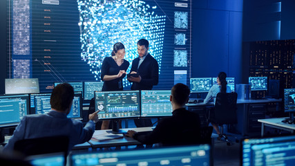 Poster - Project Manager and Computer Science Engineer Talking while Using A Digital Tablet Computer. Telecommunications System Control Monitoring Room with Neural Network on Big Screen.