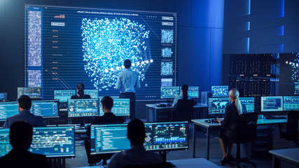 Fototapete - Team of Professional Computer Data Science Engineers Work on Desktops with Screens Showing Charts, Graphs, Infographics, Technical Neural Network Data and Statistics. Dark Control and Monitoring Room.