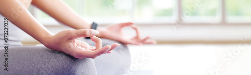 Fotografía Close up of woman hand practice yoga meditation exercise at home with copy space