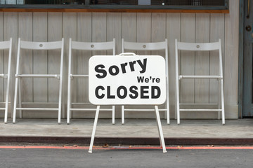 Wall Mural - sorry we are closed sign hanging outside a restaurant, store, office or other