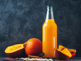 Wall Mural - Bottle of homemade pumpkin juice, fresh pumpkin on the table with copy space. healthy natural drink