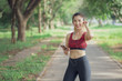 © Worranan - Women listen to music during a workout at the park.