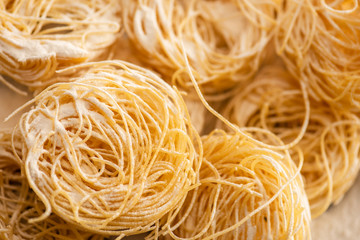 close up view of raw Italian Capellini with flour