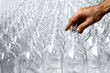 © marina - Pattern of transparent glass bottles with one hand in the process of making the healthy drink