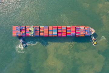 Container , container ship in export and import business and logistics. Shipping cargo to harbor by crane. Water transport International. Aerial view and top view.