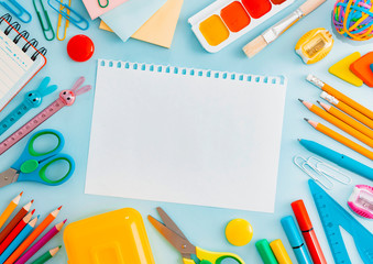 School supplies stationery on a blue background, back to school concept with copy space for text, flat lay, top view, mockup,