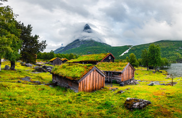 Wall Mural - Typical norwegian old wooden houses with grass roofs in Innerdalen - Norway's most beautiful mountain valley, near Innerdalsvatna lake. Norway, Europe. Landscape photography