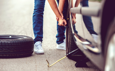 Wall Mural - Problem with a car. A broken car on the road. Changing wheel